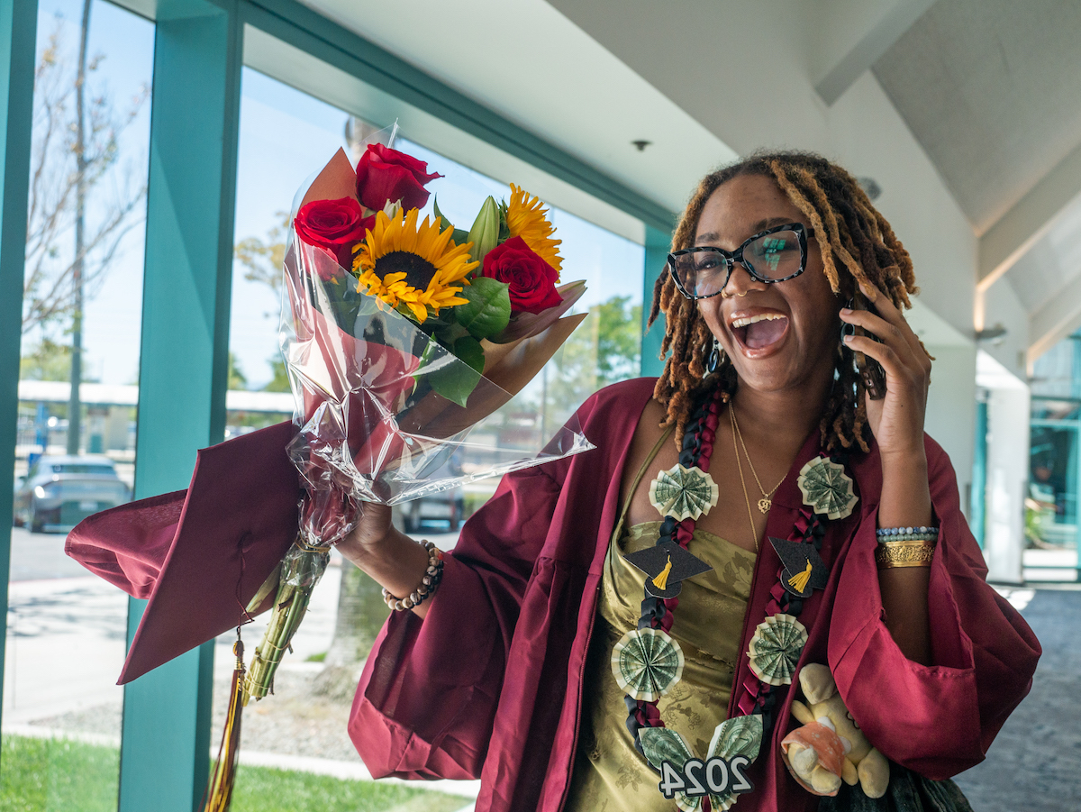 young woman in grad cap with flowers