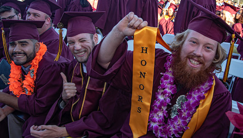 grad showing off honors sash